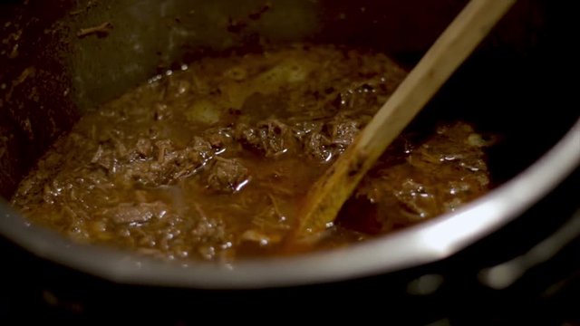 Close up pulled meat in a hot pot used for tacos. Delicious Mexican food recipe, Healthy traditional organic beef ingredient for making tacos. 