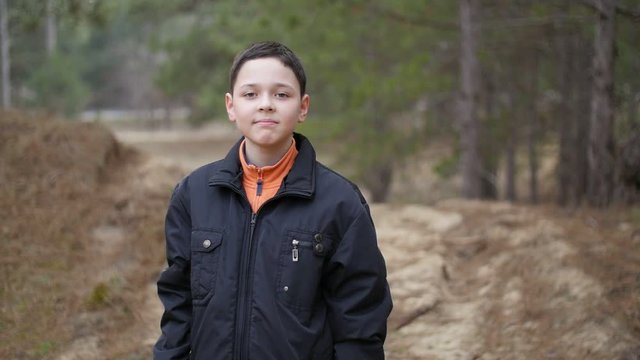 portrait of smiley boy in the forest