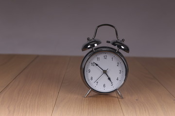 The old alarm clock on a light background
