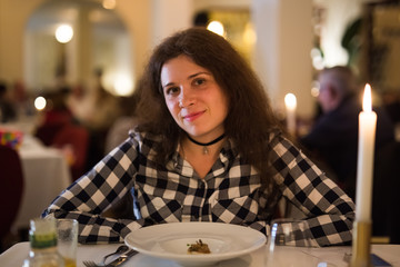 Love, relationship and date concept - Happy young woman over candlelight during romantic dinner at restaurant