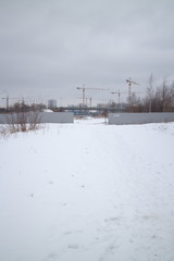 Fototapeta premium outskirts of the city next to new buildings on a winter day