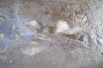 wet asphalt with pieces of snow