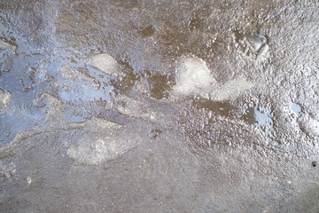 wet asphalt with pieces of snow
