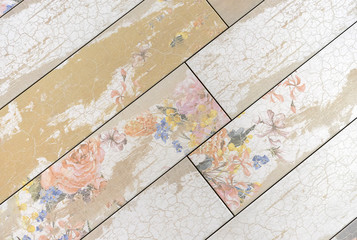Beige ceramic tiles with floral patterns. Background from beige tiles.
