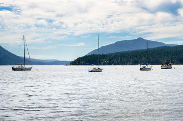 Boats in a Beautiful Bay along the Coast of Vancouver Island on a Cloudy Sumer Day. Mapple Bay, BC, Canada.