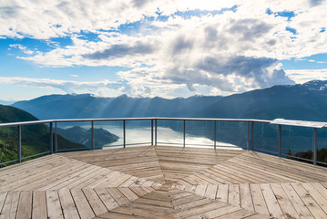 Empty Viewing Wooden Deck on the Top of a Mountain Overlooking a Fjord surrounded by Wooded...