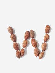 Isolated alphabet letter W made by almonds