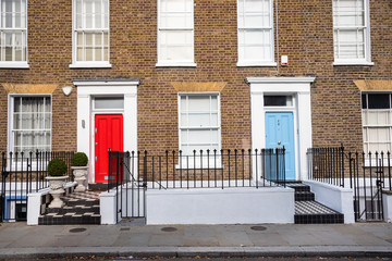 View of Traditional British Brick Terraced Houses with Colourful Wooden Front Doors
