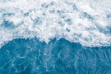 Fototapeten Pale blue sea wave during high summer tide, abstract ocean background © Bogdan