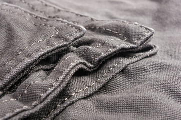 clothing items washed cotton fabric texture with seams, clasps, buttons and rivets