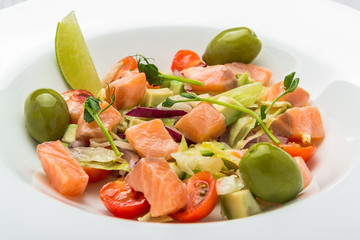Pasta salad with smoked salmon, olives, cherry tomatoes, pink pepper and fresh basil. Home made food. Symbolic image.