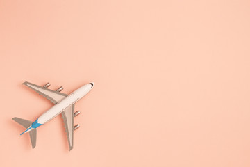 Flat lay airplane on pink background. Concept travel.