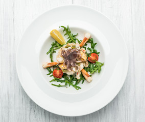 salad of seafood and vegetables with arugula and tomatoes