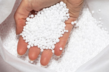 Round Styrofoam balls in my hands, the texture for the background. Environmental protection