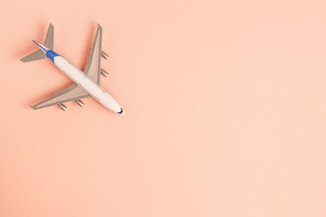 Flat lay airplane on pink background. Concept travel.