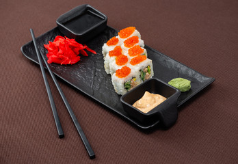 sushi on a black plate