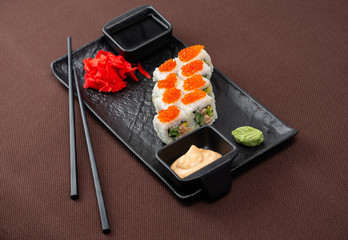 sushi on a black plate