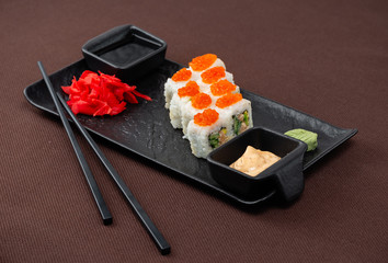 sushi on a black plate