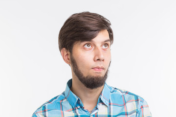 Obraz premium Process, problem, people concept - young man thinking about something on white background