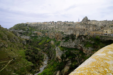 A landscape of Matera river and cityscape of The Sassi of Matera which constitute the historic...