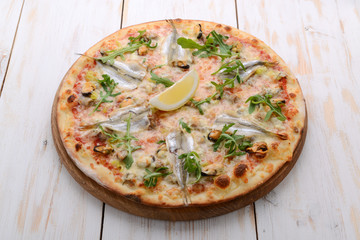 Delicious spicy Italian food, pizza with anchovies and gherkins, hot piquant meals for foodie