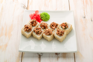 Japanese sushi roll topped with spicy salmon slice