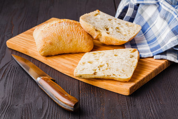 Panini with fresh tomatoes and mozzarella and prosciutto ham, Italian cuisine Slicing board