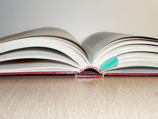 An open book with a bookmark on the table