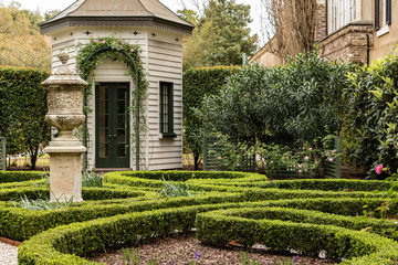 formal garden with stone building