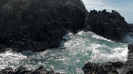 Slow motion shot of big sea waves crashing against the rocks. Waves crashing and hitting on the rocks at the sea. Palawan island, Philippines. Beautiful scenic nature landscape. S Travel concept.