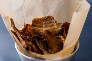 dried meat, meat chips for beer in craft paper