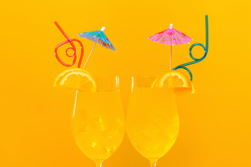 two orange cocktails on an orange background, concept cool drink in summer