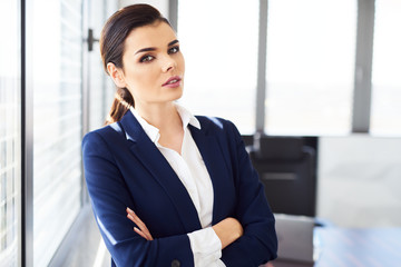 Portrait of confident businesswoman standing in modern office