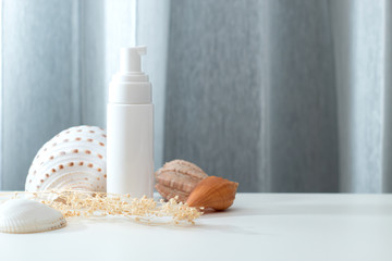 close up summer concept of spa sea beach beauty cosmetic body lotion cream sunscreen spf mockup package product with shell and flower