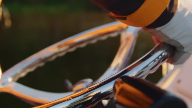 Fisherman Turns Wheel While Driving Boat - Slow Motion