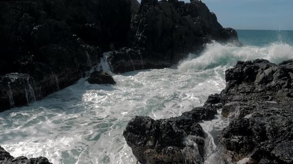 Slow motion shot of big sea waves crashing against the rocks. Waves crashing and hitting on the rocks at the sea. Palawan island, Philippines. Beautiful scenic nature landscape. S Travel concept.
