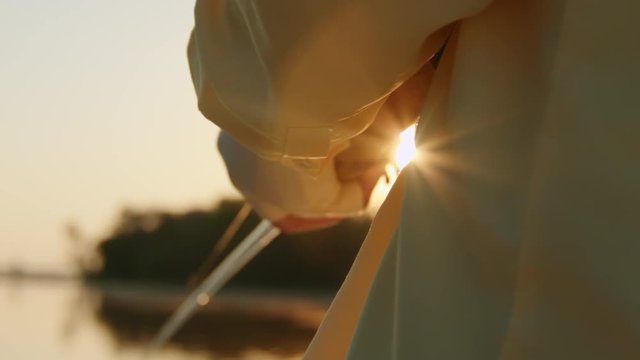 Fisherman Reels in Fish During Sunset - Slow Motion