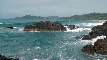 Big sea waves crashing against the rocks. Waves crashing and hitting on the rocks at the sea. Palawan island, Philippines. Beautiful scenic nature landscape. S Travel concept.