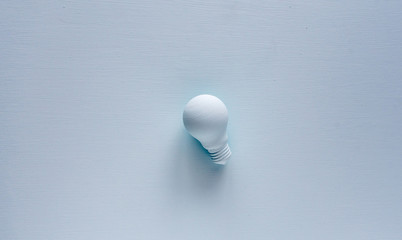 Light bulb painted with paint in pastel background. Creative idea concept. 