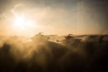 War Concept. Military silhouettes fighting scene on war fog sky background, World War Soldiers Silhouettes Below Cloudy Skyline at sunset. Attack scene. Armored vehicles.