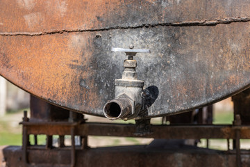 old rusty water tap from a barrel