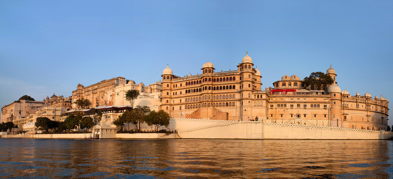 Panoramic view of the Udaipur City Palace from lake Pichola in Rajasthan, India