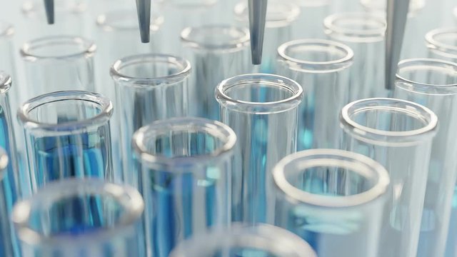 View of a glass test tubes filling with chemical composition in a laboratory. Blue colored chemical in test tube. The clip is loop ready.