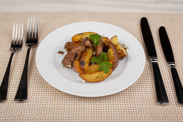 Fried potato slices in the peel on a white plate.