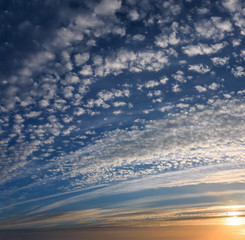 Blue sunset sky with clouds background.