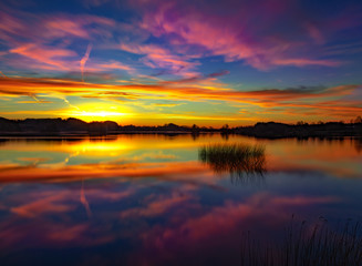 A beautiful sunset at a calm and peaceful lake - colorful sky