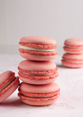 selective focus of stack with pink macarons on texutured background