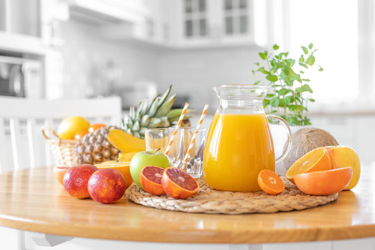 Multifruit Juice And Fresh Fruit On Table On Kitchen Background Closeup