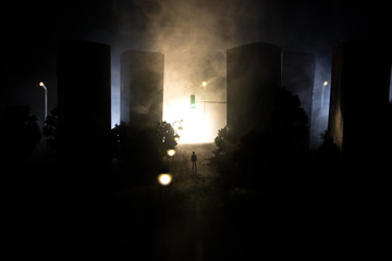 Artwork decoration. A man standing on a road of burnt up city. Apocalyptic view of city downtown as...