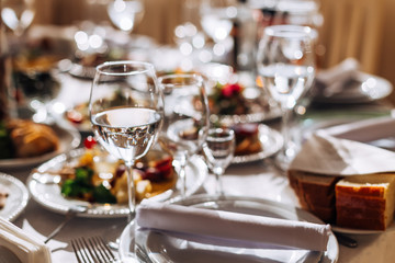 Wedding table setting. Table with food and drink. cutlery and wi